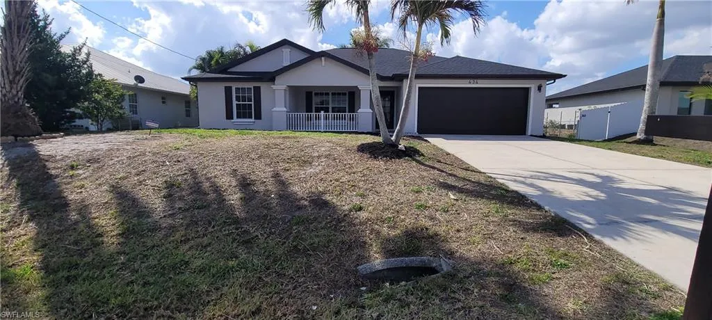 Ranch-style home featuring stucco siding, concrete driveway, an attached garage, and roof with shingles