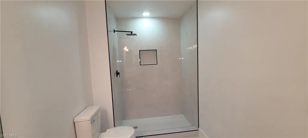 Bathroom with toilet and a shower stall
