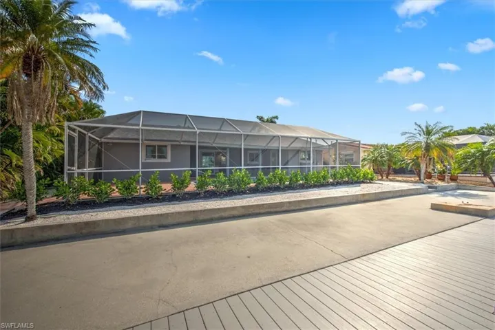 Rear view of house featuring a lanai