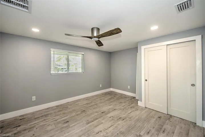 Unfurnished bedroom featuring a closet, ceiling fan, and light hardwood / wood-style floors