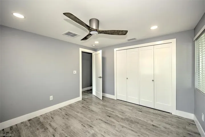Unfurnished bedroom featuring a closet, ceiling fan, and light hardwood / wood-style floors