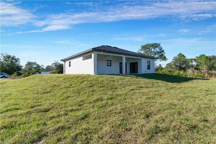 Rear view of house with a lawn