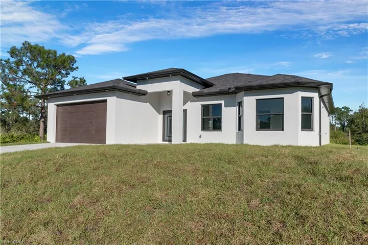 Prairie-style home with a front yard and a garage