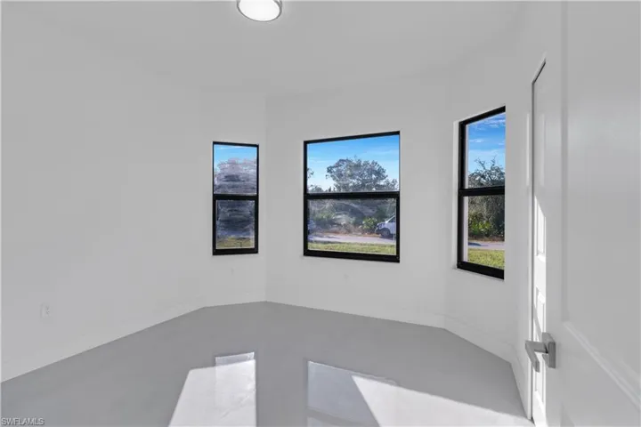 Spare room with concrete floors and a healthy amount of sunlight