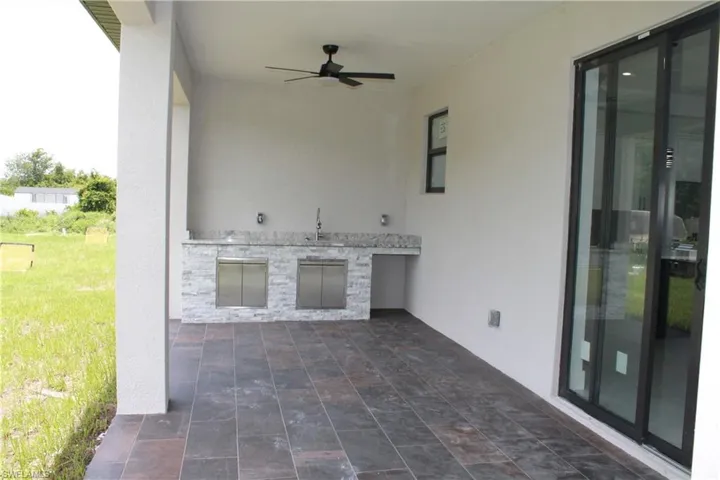 View of patio / terrace featuring an outdoor kitchen and ceiling fan