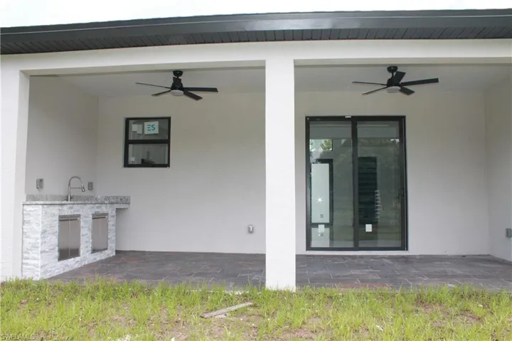 View of patio with a ceiling fan and area for grilling