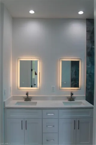 Bathroom featuring double vanity and recessed lighting