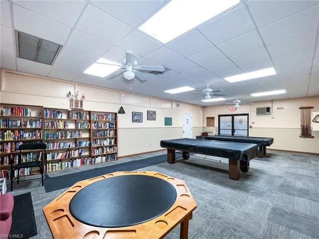 Recreation room featuring a paneled ceiling, carpet floors, ceiling fan, and pool table