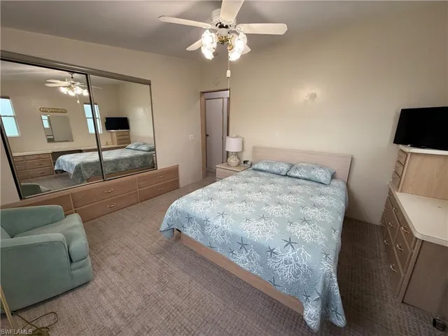 Bedroom featuring carpet, a closet, and ceiling fan