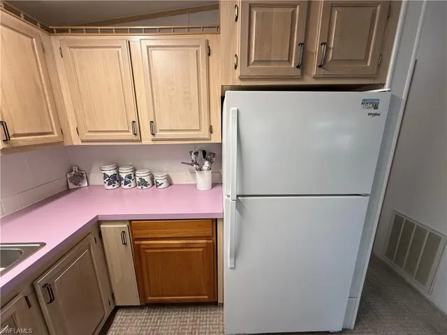 Kitchen featuring white refrigerator