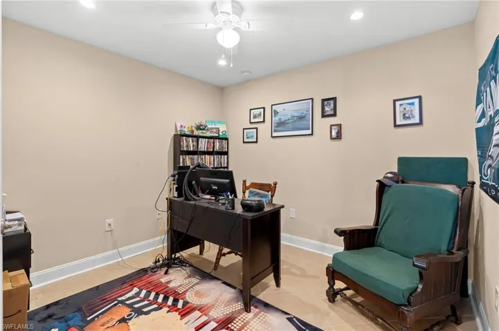 Home office featuring recessed lighting, light tile patterned floors, and ceiling fan