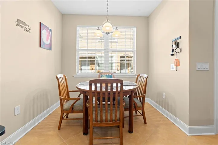 Dining room featuring light tile patterned floors and a chandelier