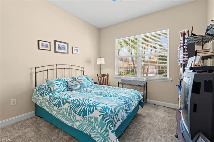 Carpeted bedroom featuring baseboards