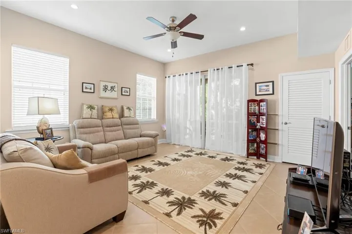 Living room featuring light tile patterned floors, recessed lighting, and a ceiling fan