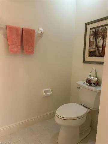 Bathroom with toilet and tile floors
