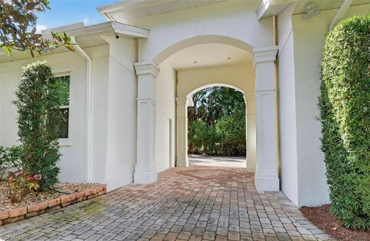 Doorway to property featuring stucco siding