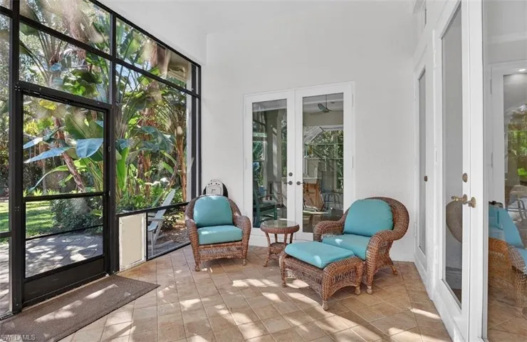 Sunroom featuring french doors and tile patterned flooring