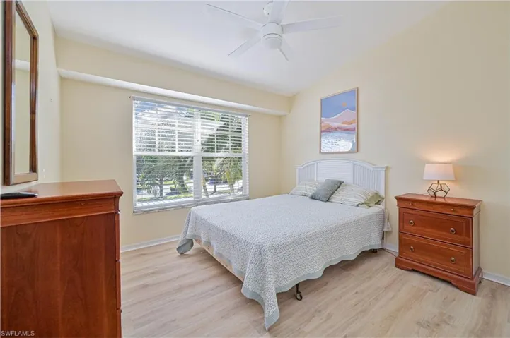 Bedroom featuring light wood finished floors, a ceiling fan, and vaulted ceiling