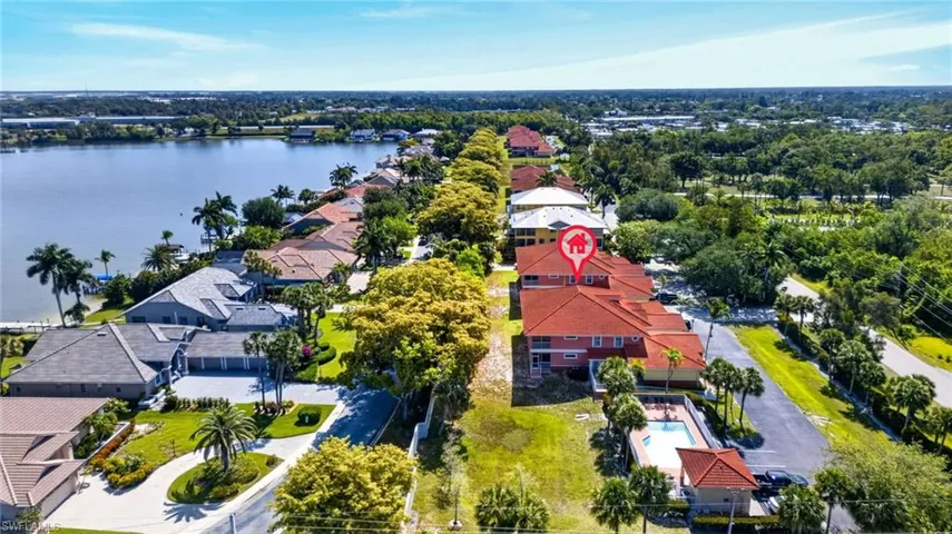 Aerial perspective showcasing waterfront properties along a sizable body of water
