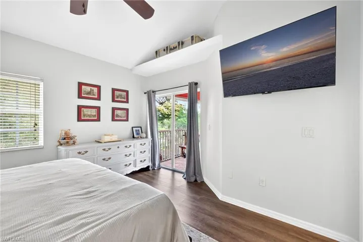 Interior space featuring wood-finish flooring, vaulted ceiling, and a ceiling fan