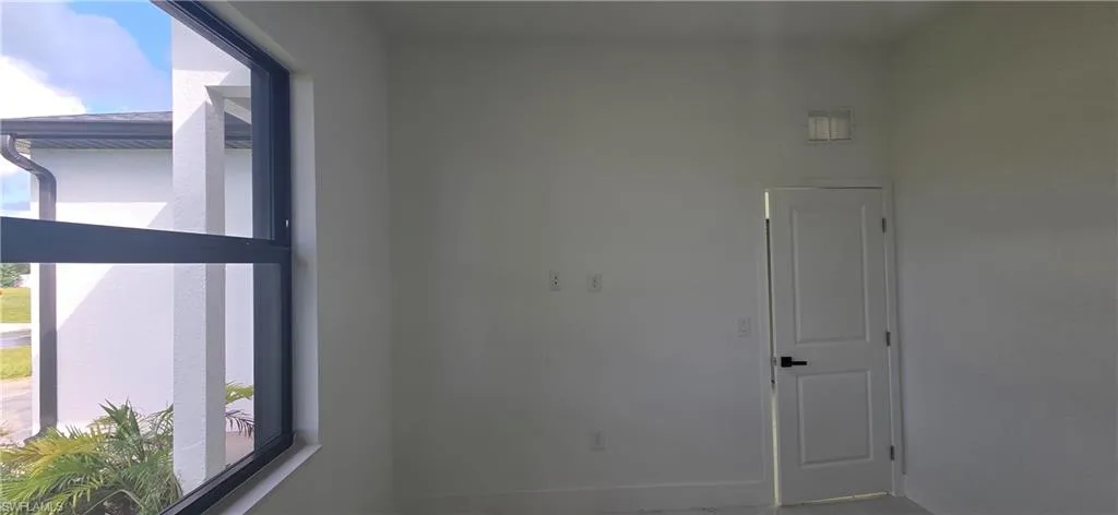 Unfurnished room featuring baseboards