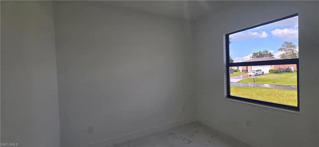 Spare room featuring baseboards and light marble finish flooring