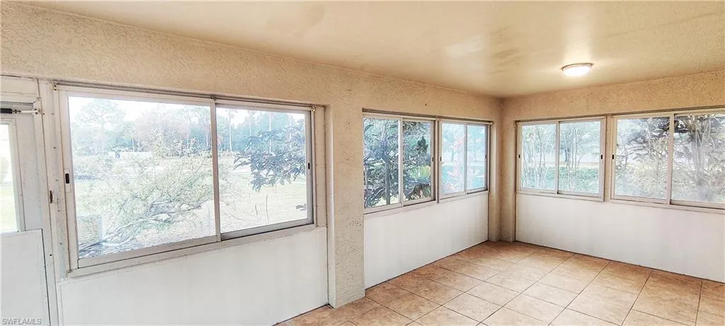 Unfurnished sunroom featuring a wealth of natural light