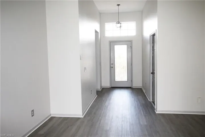 Entrance foyer featuring a high ceiling and dark hardwood / wood-style flooring