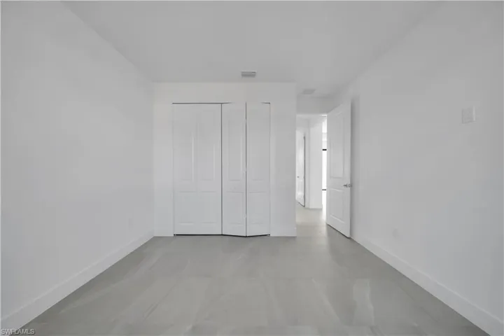Unfurnished bedroom featuring baseboards and a closet