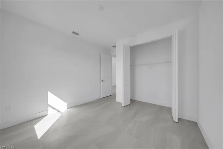 Unfurnished bedroom featuring baseboards and a closet