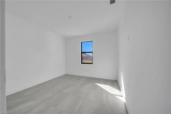 Empty room featuring baseboards and light flooring