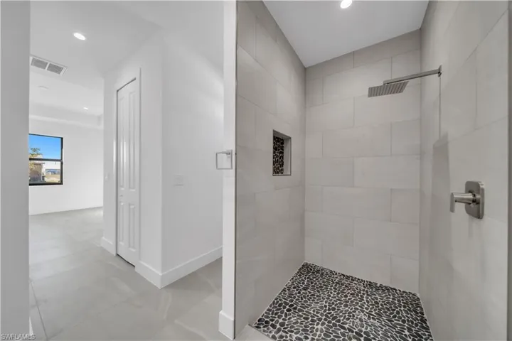 Full bath with a shower stall and recessed lighting