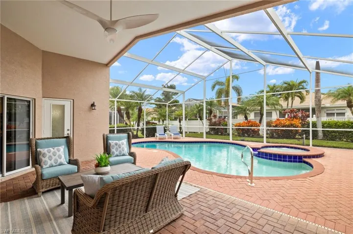 View of pool featuring a lanai, a patio area, and an in ground hot tub