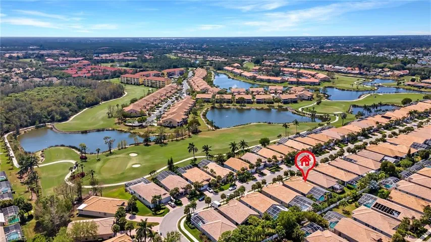Birds eye view of property with a water view