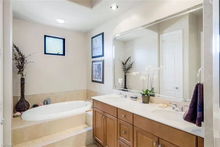 Bathroom featuring double vanity and Soake tub. Glass shower not shown.