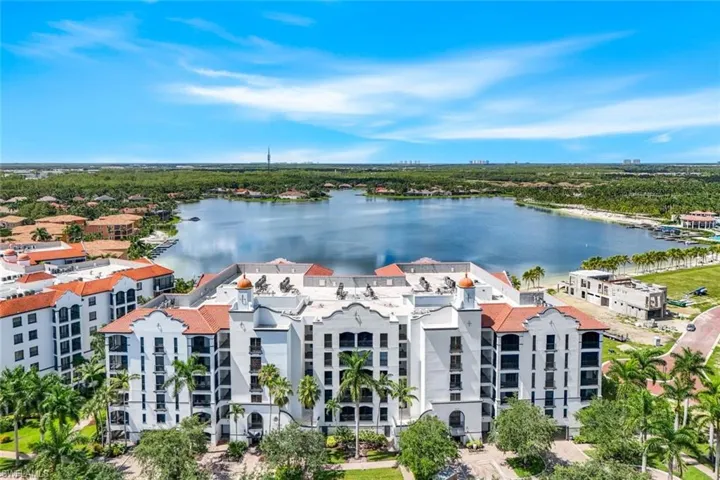 This 5th floor home is in the back right corner of this photo overlooking the beach and smallest of the 3 interconnected Miromar Lakes. Unobstructed lake and year-round sunset views.
