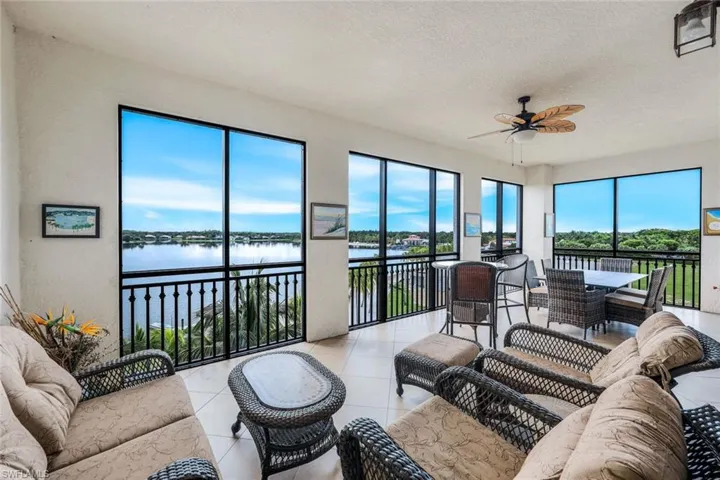 Tiled screened lanai living room overlooking beach, lake and daily sunsets