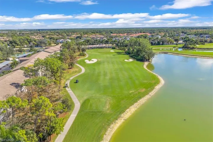Aerial perspective of suburban area with a large body of water and a golf club