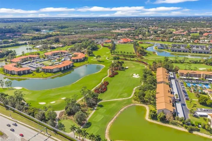 Drone / aerial view of a golf course and a large body of water