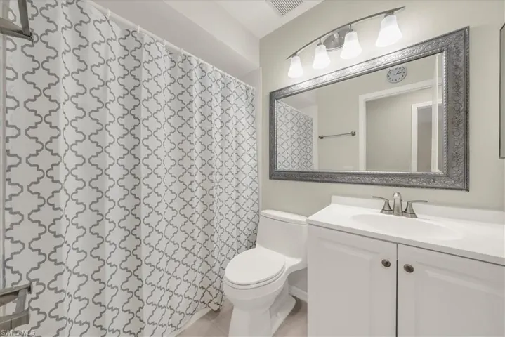 Bathroom featuring vanity and a shower with shower curtain