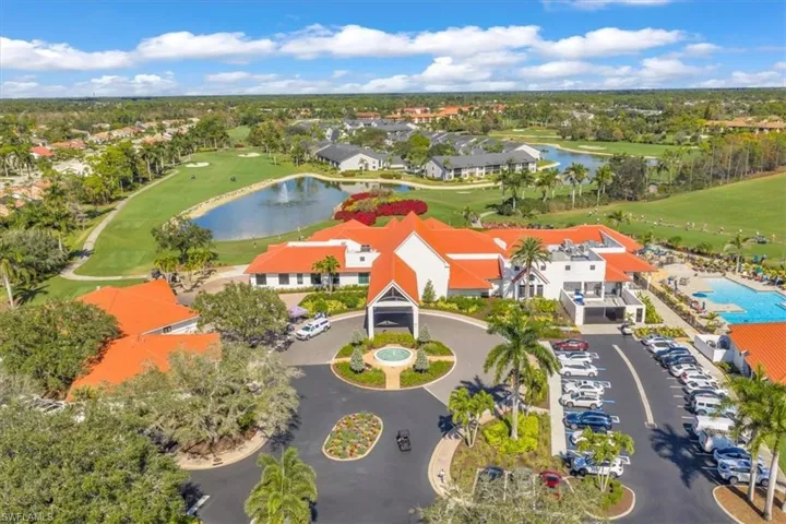 Drone / aerial view of a nearby body of water and a golf course