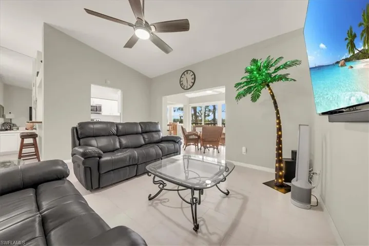 Living area featuring vaulted ceiling and ceiling fan