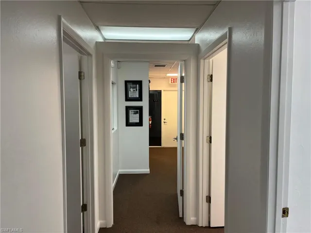 Hall featuring dark carpet