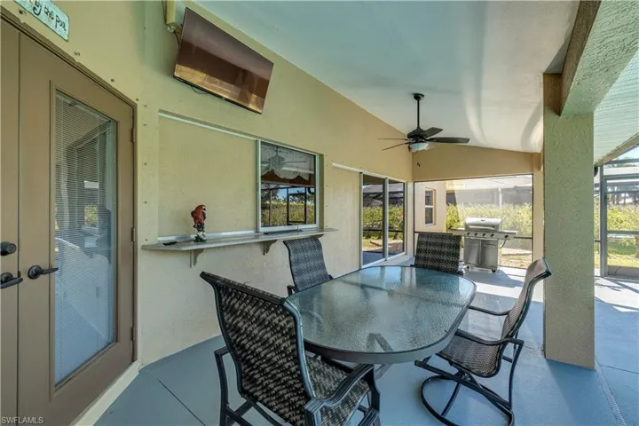 View of patio / terrace with outdoor dining area, ceiling fan, and a grill