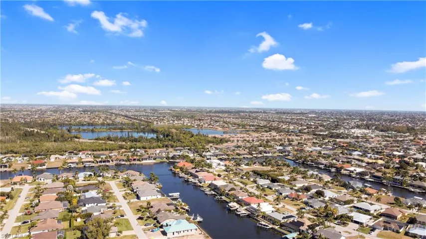 Aerial perspective of suburban area with a large body of water