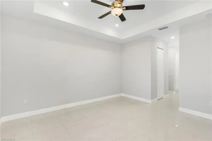 Primary bedroom with tray ceilings