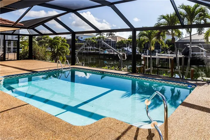 View of pool featuring a water view, a lanai, and a patio