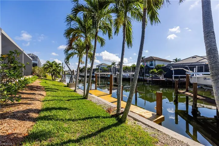 Dock area featuring a lawn and a water view