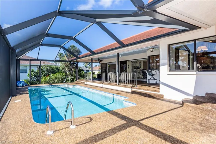 View of swimming pool featuring ceiling fan, a lanai, and a patio