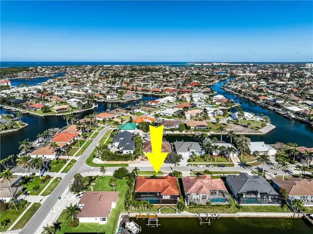 Birds eye view of property with a water view